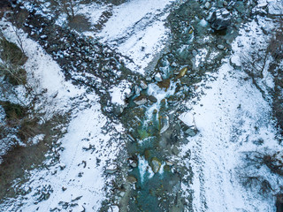 Beautiful river flowing through frozen snow covered landscape