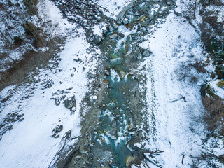 Beautiful river flowing through frozen snow covered landscape