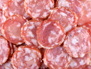 Salami sausage slices background. Close up. Slices of smoked sausage. Food background.