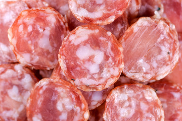 Salami sausage slices background. Close up. Slices of smoked sausage. Food background.