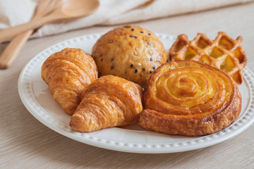 Various baked bread on plate.