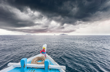 Traveling boat go to island while raining strom near comes