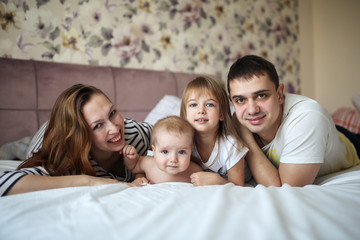 Siblings girl and brother baby with mom and dad