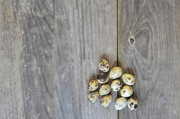 Quail eggs lay in a pile on a wooden vintage background. The concept of healthy eating benefits