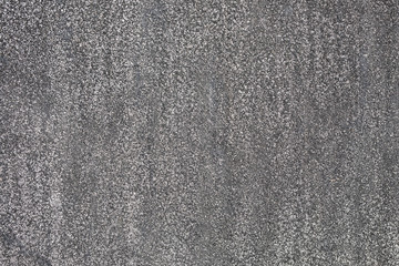 Ruberoid. Abrasive texture roofing material close-up. Abstract dark granular background.