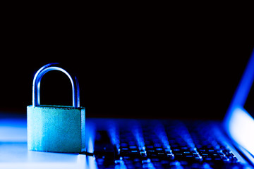Padlock on laptop. Internet data privacy information security concept. Antivirus and malware defense. Blue toned