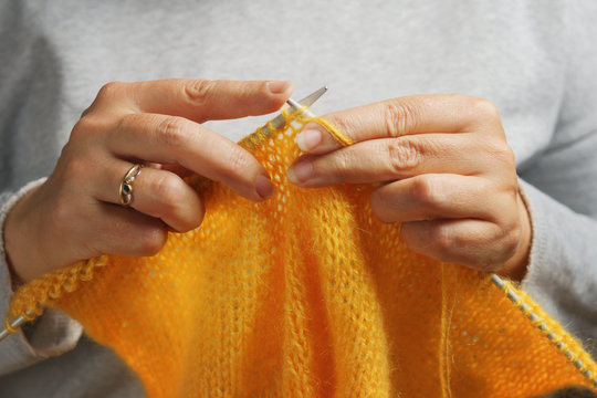 Woman Hands With Knitting Needles And Wool Yarn. Needlework Concept.