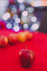 apples symbol of healthy food and Christmas tree in the background