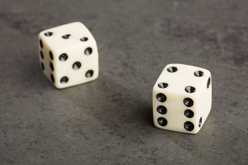 Two white dice on gray background - Text space