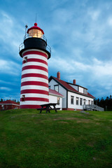 Storm Clouds Gather Around Red and White Striped Lighthouse in New England