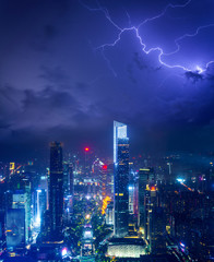 Night cityscape of guangzhou urban skyscrapers at storm with lightning  bolts in night purple blue sky, Guangzhou, China
