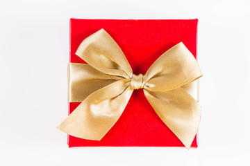 Wrapped gift with a golden ribbon on a white background