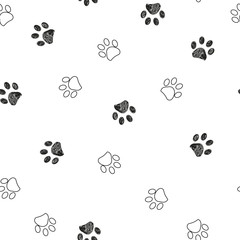 Fototapeta premium Black and white paw print repeated pattern