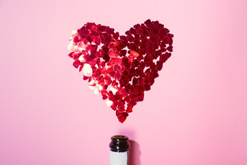 Heart of red sequins on pink background