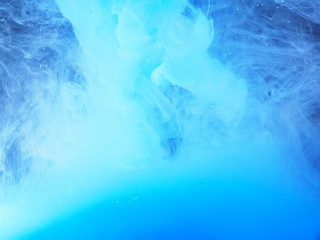 Blue paint is mixed with water. The dissolution of ink in water.