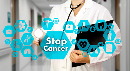 Medical Doctor with stethoscope and Stop Cancer sign in Medical network connection on the virtual screen on hospital background.Technology and medicine concept.