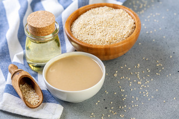 Bottled sesame oil, tahini and white sesame seeds.