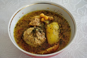 Traditional Azerbaijani Kufta bozbash -  pea soup with lamb meatballs, made of minced meat and rice, zesty dried plum inside and boiled potatoes topped with dried mint and sumac