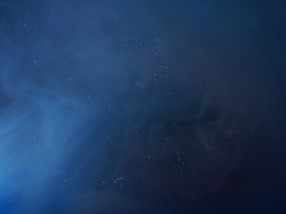 Blue paint is mixed with water. The dissolution of ink in water.