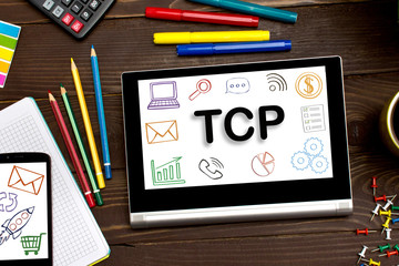 TCP Transmission Control Protocol the inscription on the touch-screen tablet on the table of a businessman