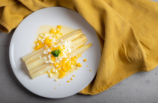 cooked white asparagus with butter and boiled eggs