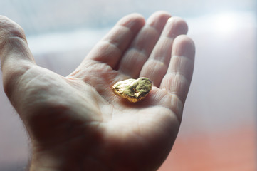 man holding golden nugget