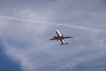Fototapeta na wymiar Airplane flying on a sunny day