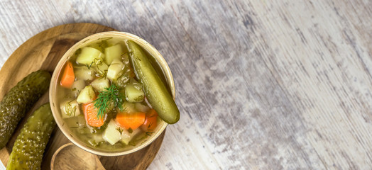 Vegetarian soup made of pickled cucumbers - light color of background - banner top view with space for text.