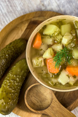 Vegetarian soup made of pickled cucumbers - light color of background - vertical view