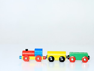 wooden toy train on a white surface