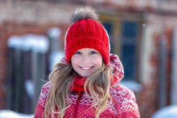 Portrait of a cheerful child in the winter outdoors