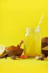 Lemon water with ginger, curcuma, black pepper. Vegan hot drink concept. Ingredients for orange turmeric drink on btight yellow background