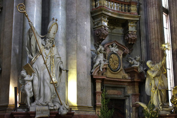 Fototapeta na wymiar Prague / Czech Republic - January 31 / 218 : St. Cyril of Alexandria holding a crook towards a man and an angel is holding a book at St. Nicholas church