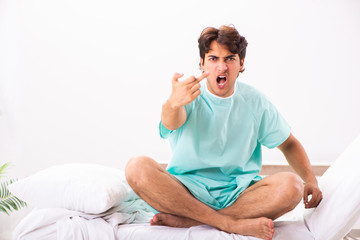 Young handsome man staying in hospital 