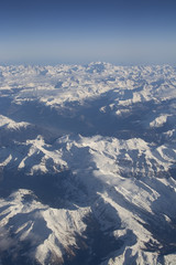 Fototapeta premium Swiss Alpes with snowy mountain tops aerial