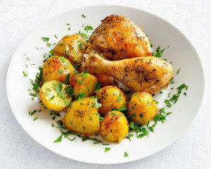 oven baked chicken and potato decorated with parsley
