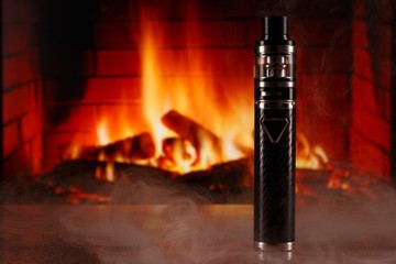electronic cigarette within vapor on fireplace background