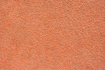 Orange tartan surface of a running track as texture, background