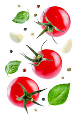 Flying fresh tomatoes on a white background