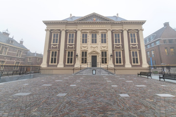 Obraz premium Majestic Dutch Parliament buiding. and Mauritshuis entrance under a misty and foggy weather with nobody listed as RF like the picture 1213013458