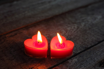 Heart shaped candles burning