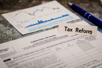 Tax Reform still life business finance concept with laptop, stock chart, shallow DOF