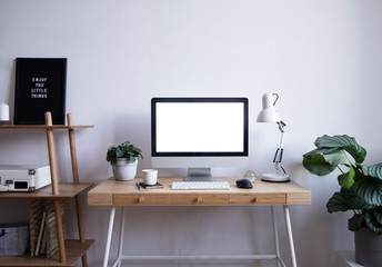 Modern scandinavian interior of home desk with mock up computer screen, plants, bookstand and...