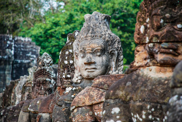 Intricately sculpted heads in the temples of Angkor Wat