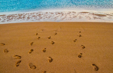 Beach sand footprint ocean coast sea azure wave with bubble. Human steps on shore