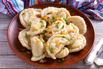 Dumplings, filled with cabbage. Varenyky, vareniki, pierogi, pyrohy - dumplings with filling