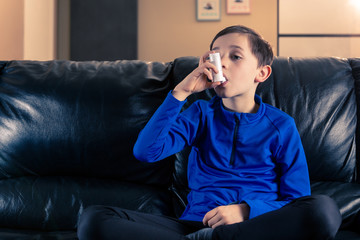 Fototapeta premium Boy holding asthma inhaler