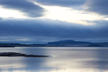 Thingvallavatn lake with reflection of sun during winter near sunrise