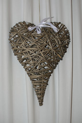 Brown rattan heart with white bow