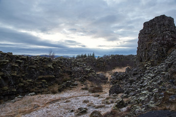 Thingvellir, Iceland - July 19, 2017: Tourists walk through the Almannagja fault line in the mid-atlantic ridge north american plate in Thingvellir National Park. Iceland